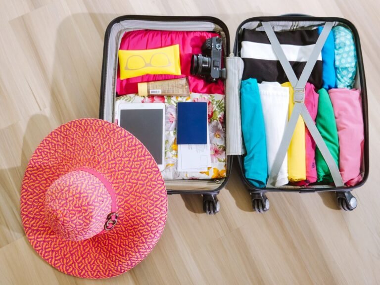 Open suitcase packed with colorful clothes